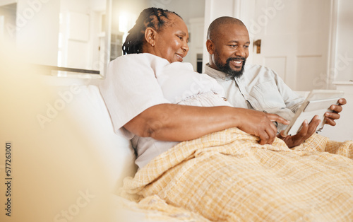 Memory, photo album and love with a black couple sitting on a sofa in the living room of their home together. Nostalgia, retirement or relax with a senior man and woman looking at photographs