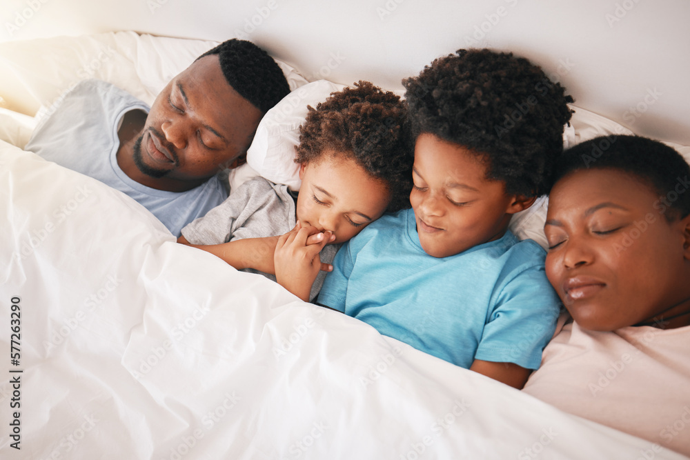 Sleeping, black family and children with parents in a bed feeling tired in the morning. Bonding, parent love and support with kids, dad and mother resting at home in a house bedroom together Sleeping, black family and children with parents in a bed feeling tired in the morning. Bonding, parent love and support with kids, dad and mother resting at home in a house bedroom together