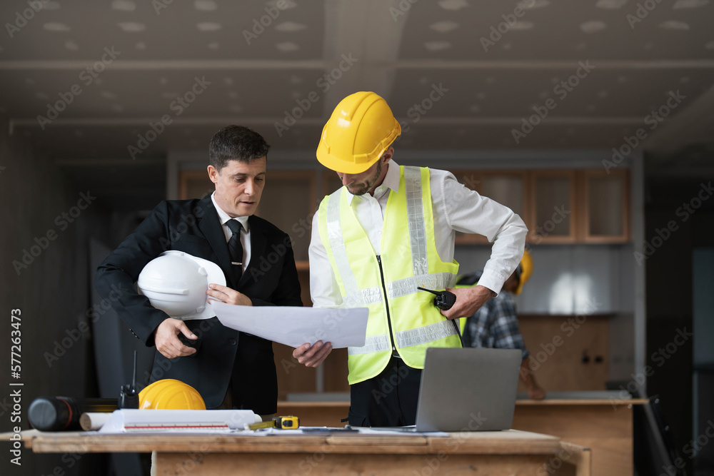 Diverse Team of Specialists Use Laptop on Construction Site. Real Estate Building Project with Engineer Investor and Businessman Checking Area, working on Civil Engineering, Discussing Strategy Plan Diverse Team of Specialists Use Laptop on Construction Site. Real Estate Building Project with Engineer Investor and Businessman Checking Area, working on Civil Engineering, Discussing Strategy Plan