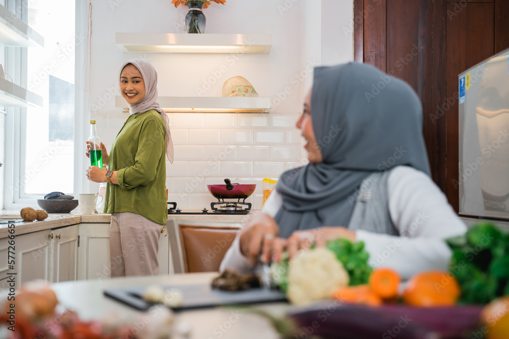 muslim woman friend preparing some food for dinner in the kitchen muslim woman friend preparing some food for dinner in the kitchen