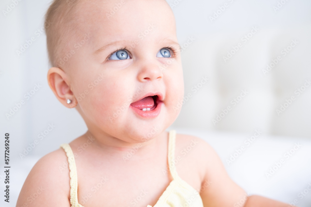portrait of cute baby girl smiling with first milk teeth. Healthy newborn child portrait of cute baby girl smiling with first milk teeth. Healthy newborn child