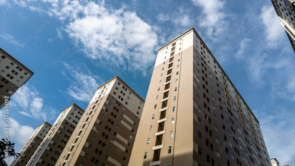 High rise apartment building complex with blue sky High rise apartment building complex with blue sky