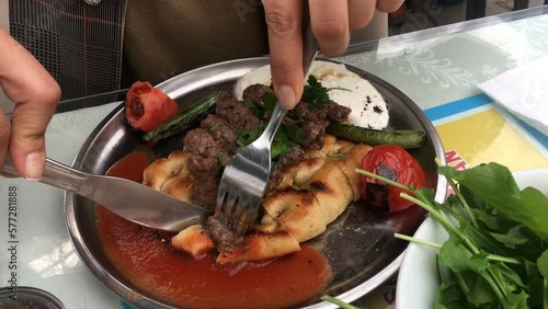 Eating Turkish kebab döner with bread and yoghurt
