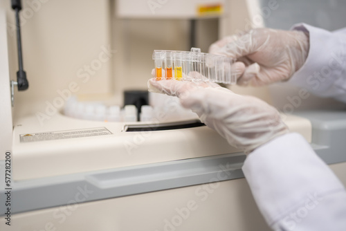 Lab technician holding test tubes