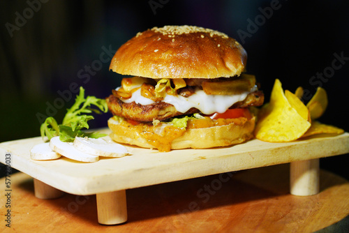 Burger served on a wooden plate