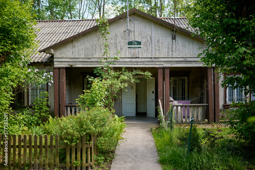 Wooden houses of Osiedle "Przyjaźń" in Warsaw surrounded by summer greenery