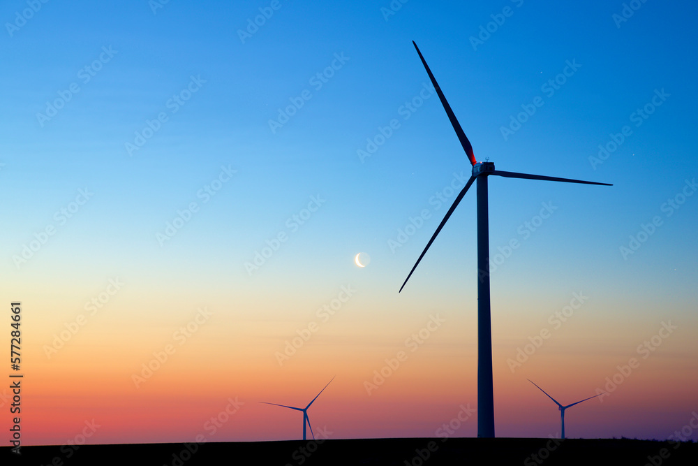 Silhouettes of a group of wind turbines at sunrise. Silhouettes of a group of wind turbines at sunrise.