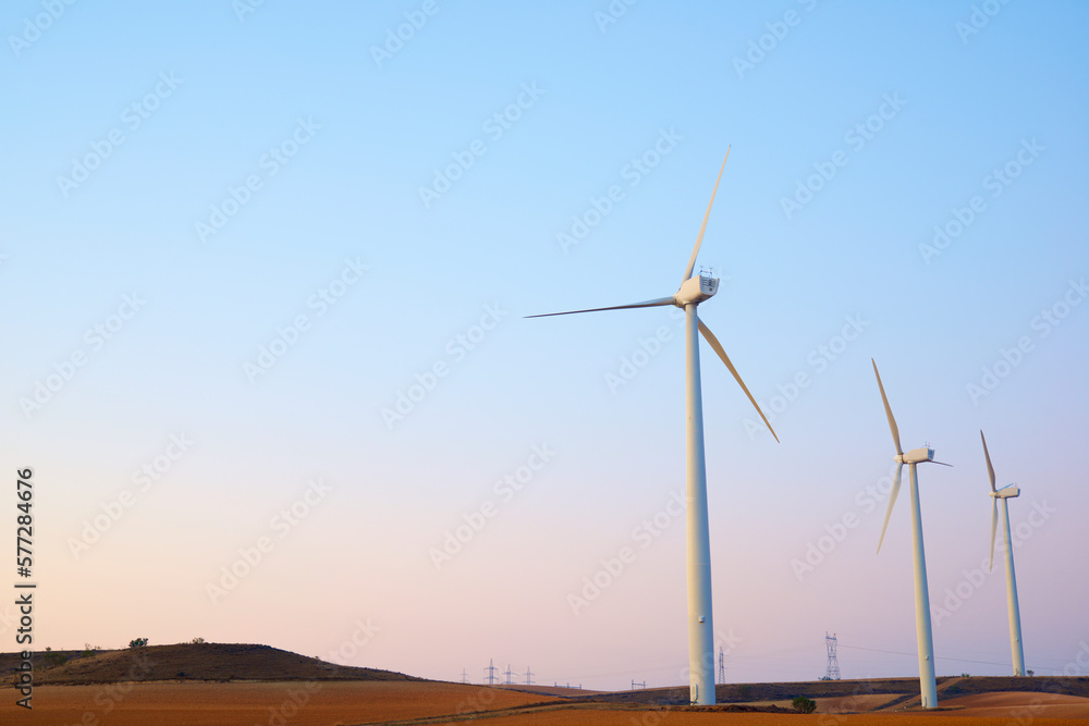 Wind turbines for the production of renewable electricity at dawn.