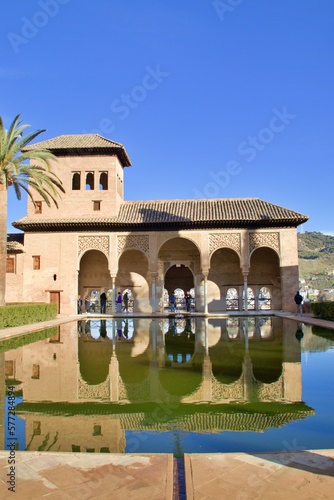 reflection of the Andalusian palace on the patio fountain