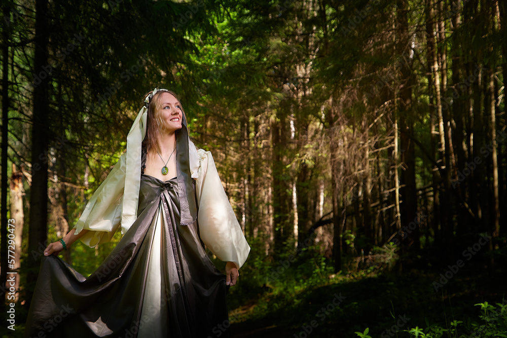 Beautiful seductive dryad. Pagan spirit of the forest. Portrait of beautiful dryad. Fairy who loves nature in beautiful green summer forest. Concept of environmental friendliness and caring for nature Beautiful seductive dryad. Pagan spirit of the forest. Portrait of beautiful dryad. Fairy who loves nature in beautiful green summer forest. Concept of environmental friendliness and caring for nature