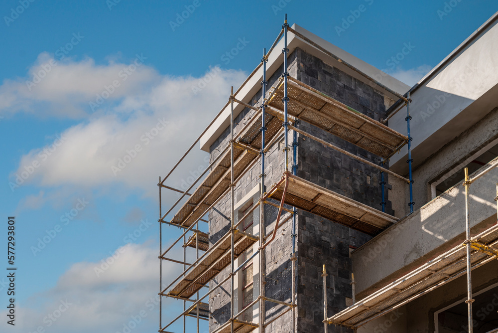 Construction scaffolding built on a new apartment building. new construction under construction