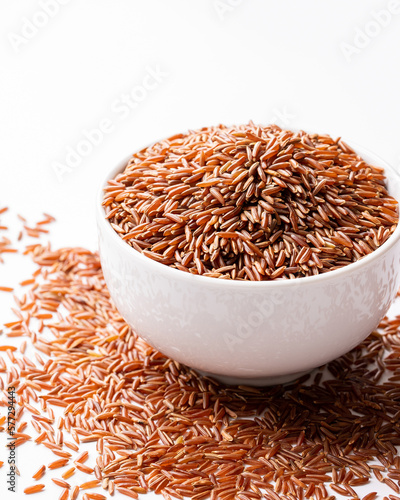 Orgnaic Raw Red Rice In a White Ceramic Bowl. Healthy Diet Concept photo