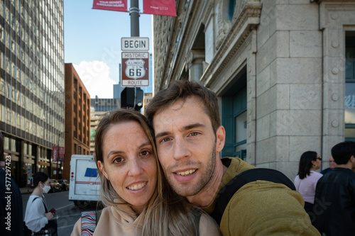 Selfie of a young couple under the sign of the start of route 66