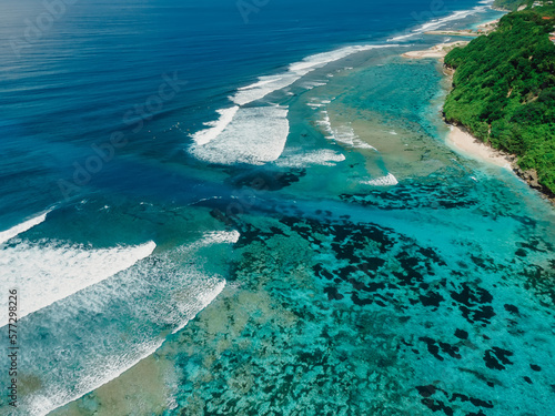 Balinese coastline with ocean with waves and powerful current in Bali. Aerial view © artifirsov