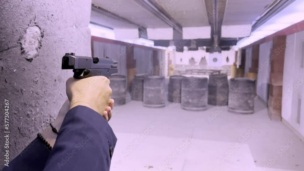 Woman Shooting with a 9 mm Handgun in Shooting Range in Switzerland.