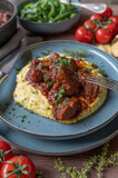 Meat dish for sunday or holiday with a delicious italian pork ragout, creamy polenta and green beans on a plate