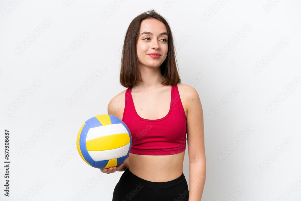 Young Ukrainian woman playing volleyball isolated on white background looking side Young Ukrainian woman playing volleyball isolated on white background looking side