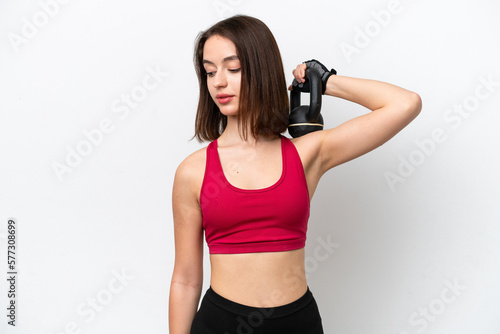 Young Ukrainian woman isolated on white background making weightlifting with kettlebell © luismolinero