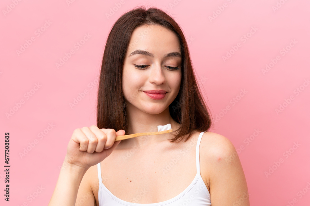Young Ukrainian woman isolated on pink background with a toothbrush Young Ukrainian woman isolated on pink background with a toothbrush