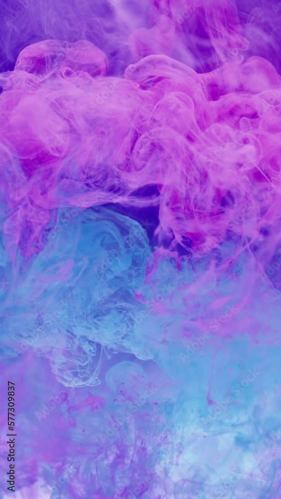 Vertical video. Ink water. Paint splash. Color explosion. Neon pink blue smoke cloud burst mix floating motion abstract art background shot on RED. Vertical video. Ink water. Paint splash. Color explosion. Neon pink blue smoke cloud burst mix floating motion abstract art background shot on RED.
