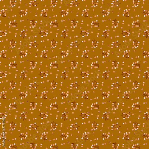 Cute delicate botanical pattern of blooming twigs flat lay on dark yellow - brown background