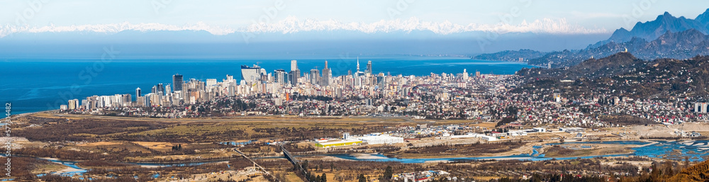 Panoramic view of Batumi city in Georgia. Landscape from the top, against the background of the mountain and the Caucasus Range and Elbrus. Spring. Skyscrapers. Adjara region. Black Sea and tourism
