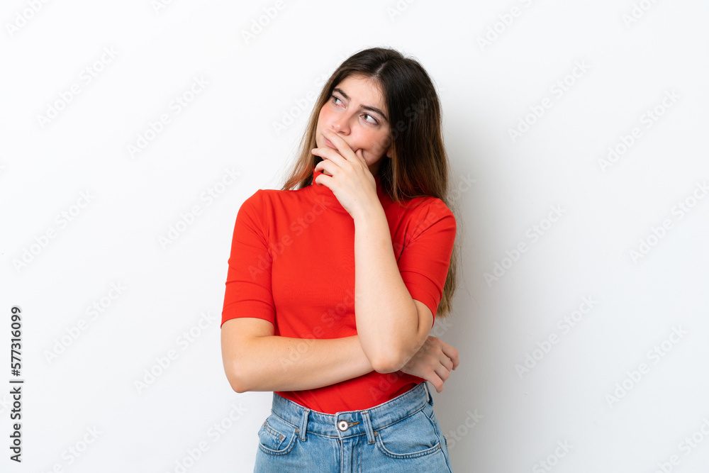 Young caucasian woman isolated on white background having doubts and with confuse face expression Young caucasian woman isolated on white background having doubts and with confuse face expression