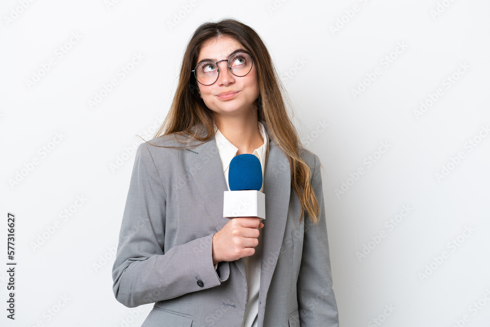 Young caucasian TV presenter woman isolated on white background and looking up Young caucasian TV presenter woman isolated on white background and looking up