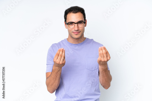 Young caucasian man isolated on white background making money gesture but is ruined