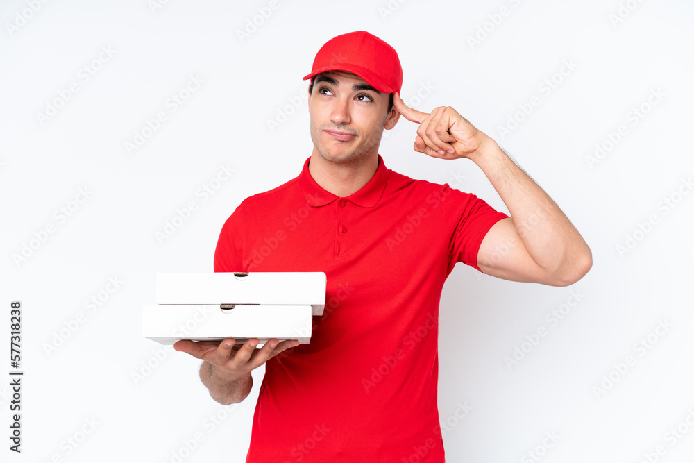 Pizza delivery caucasian man with work uniform picking up pizza boxes isolated on white background having doubts and thinking Pizza delivery caucasian man with work uniform picking up pizza boxes isolated on white background having doubts and thinking