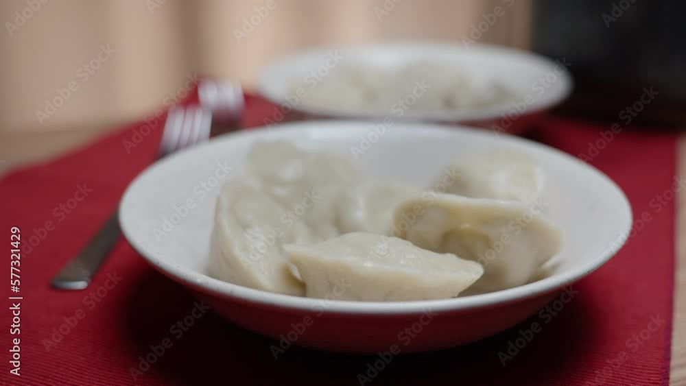I pour hot broth over the dumplings. close-up slow motion. I pour hot broth over the dumplings. close-up slow motion.