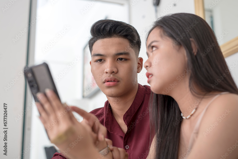 A young woman confronts her boyfriend over suspicious messages or racy