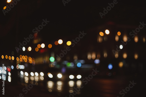 Colorful lights of urban city surrounding moving and blurred by motion. the light trails on the street. Blurred defocused lights of city traffic  © paralisart
