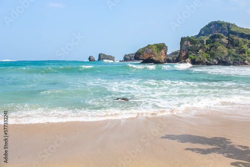 Tropical paradise beach with white sand and cliffs and blue sky with clouds on Sunny day. Summer tropical landscape, panoramic view. travel tourism wide panorama background concept. 