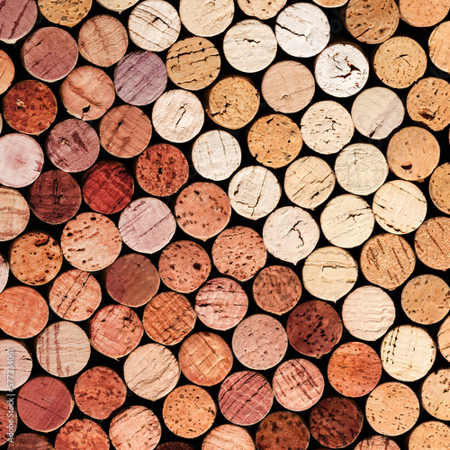 Collection of wine cork from white and red wine, natural texture bottle stoppers top view, colorful background from wooden corks. Natural textured stoppers colored. Winery, winemaking concept.