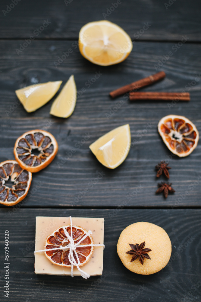 Handmade soap bars and citrus fruit on dark table top view. Piece of handmade lemon soap and fresh lemons Handmade soap bars and citrus fruit on dark table top view. Piece of handmade lemon soap and fresh lemons