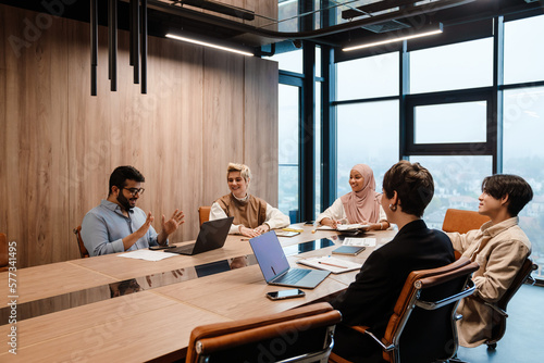 Group of businesspeople colleagues discussing project during meeting in conference room