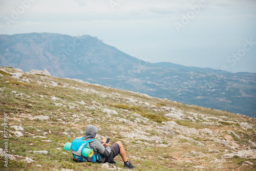 a man with a backpack on the mountain on a hike trip