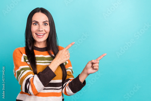 Photo of surprised girl brunette hair fingers directing empty space unbelievable last chance buy sale shopping isolated on cyan color background