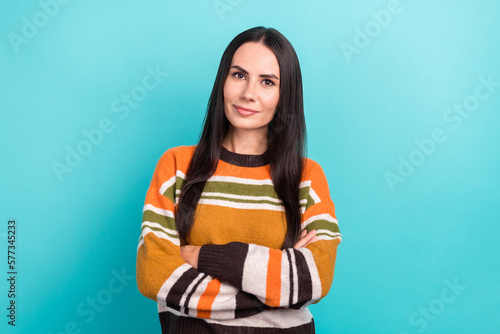 Portrait of young serious confident business lady casual trendy striped sweater professional seo company worker isolated on cyan color background