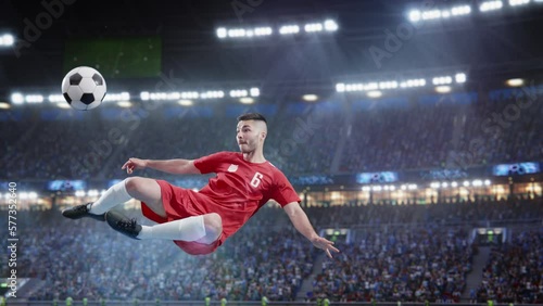 Aesthetic Shot Of Athletic Soccer Football Player Doing Beautiful Overhead Kick On Stadium With Crowd Cheering. International Championship Final Match on Arena Full Of Fans. Super Slow Motion. photo