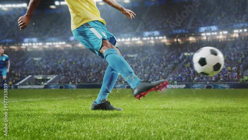 Aesthetic Shot Of Athletic Hispanic Footballer Shooting A Penalty Kick On Stadium With Crowd Cheering. International Soccer Championship Final Match With Fans On Tribune. Super Slow Motion.