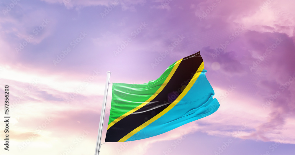 Waving Flag of Tanzania in Blue Sky. The symbol of the state on wavy cotton fabric.