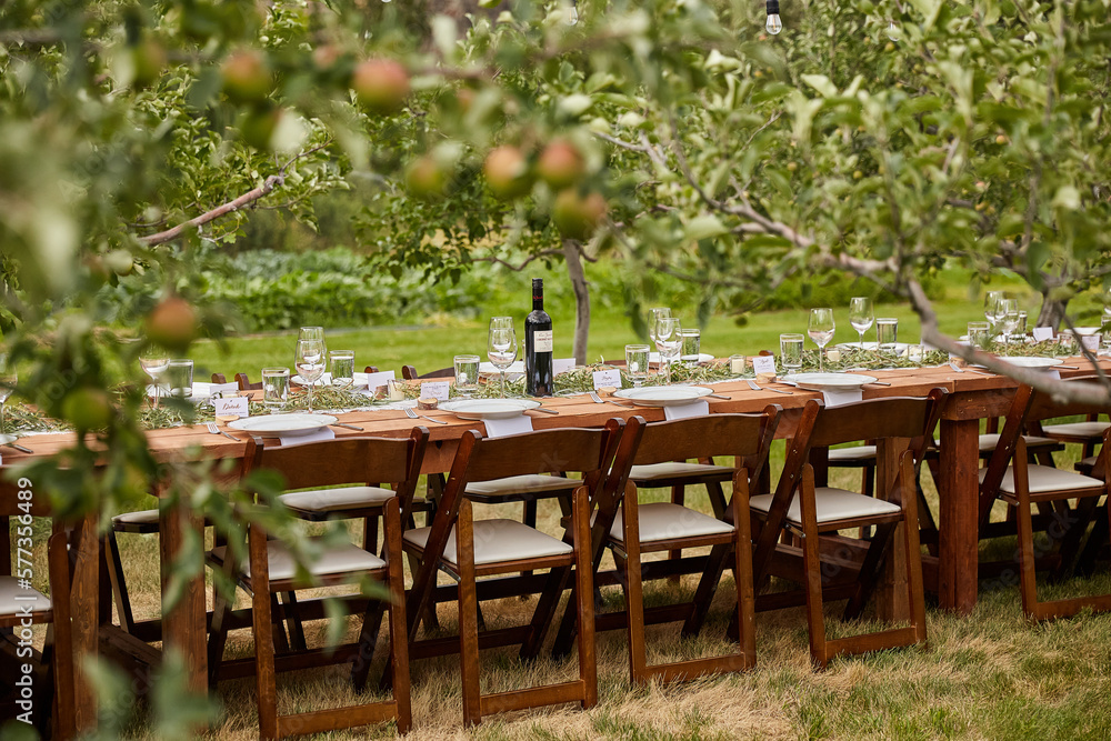 Obraz premium Wedding table in an apple orchard, ready for guests.