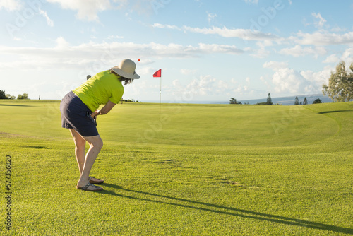 Woman Golfer Getting the Golf Ball onto the Putting Green