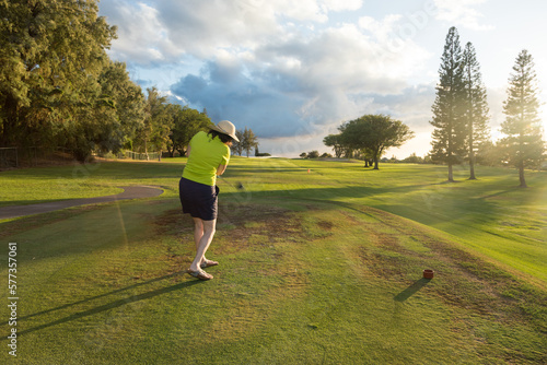 Woman Golfer Teeing Off on a Golf Course