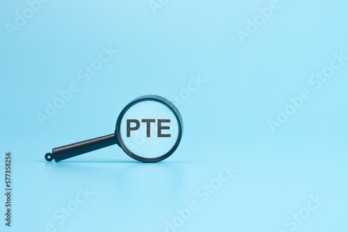 look at the text PTE through a magnifying glass on a blue background