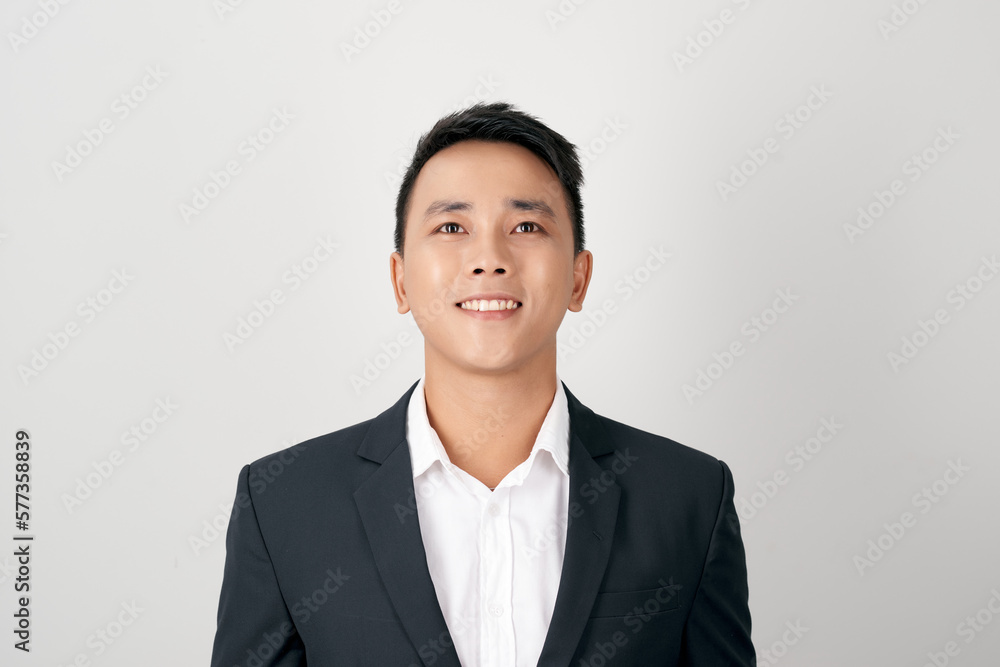 portrait of young handsome southeast Asian businessman looking up on white background portrait of young handsome southeast Asian businessman looking up on white background