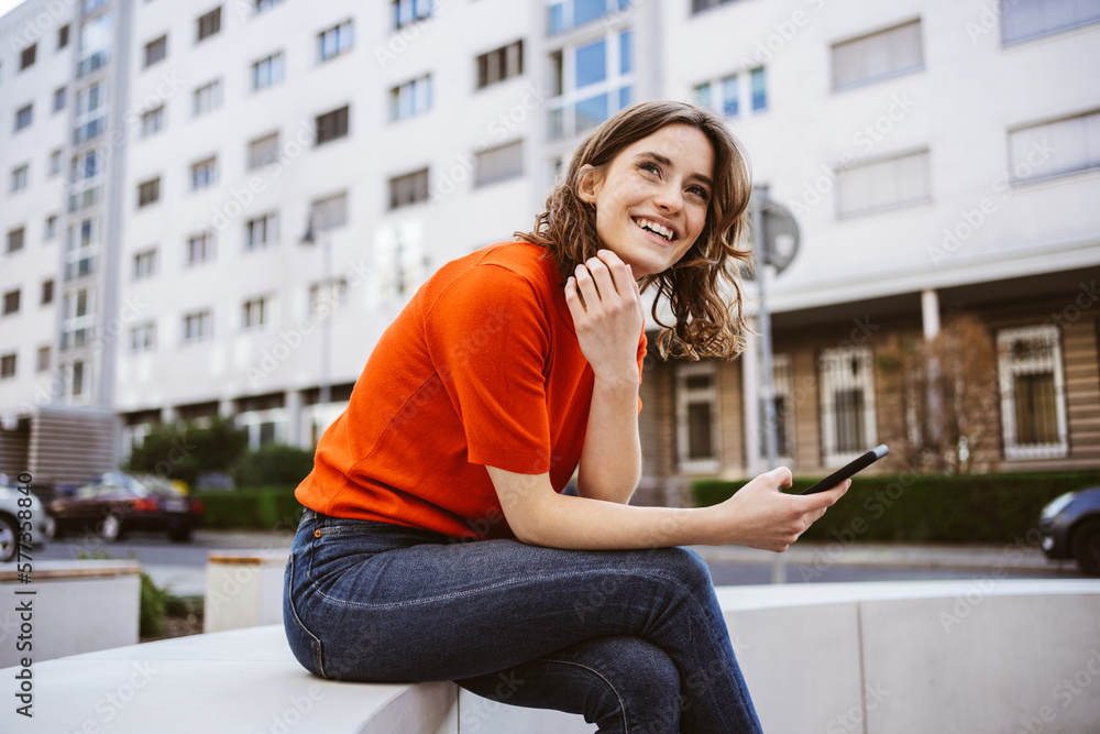 Cheerful Young Woman Enjoying City Life with Smartphone Cheerful Young Woman Enjoying City Life with Smartphone