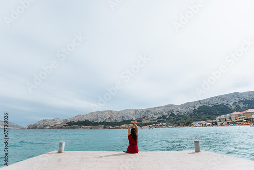 girl on the pier near the sea © Vasil
